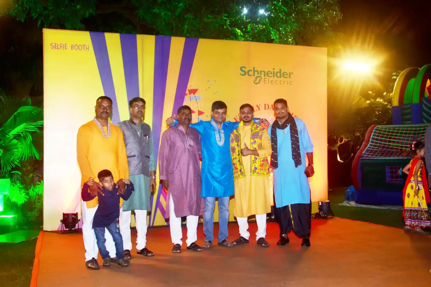 Man and woman speaking on stage at night with blue lighting